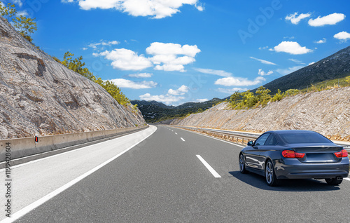 Obraz na płótnie Car is driving along the highway surrounded by picturesque nature. w salonie