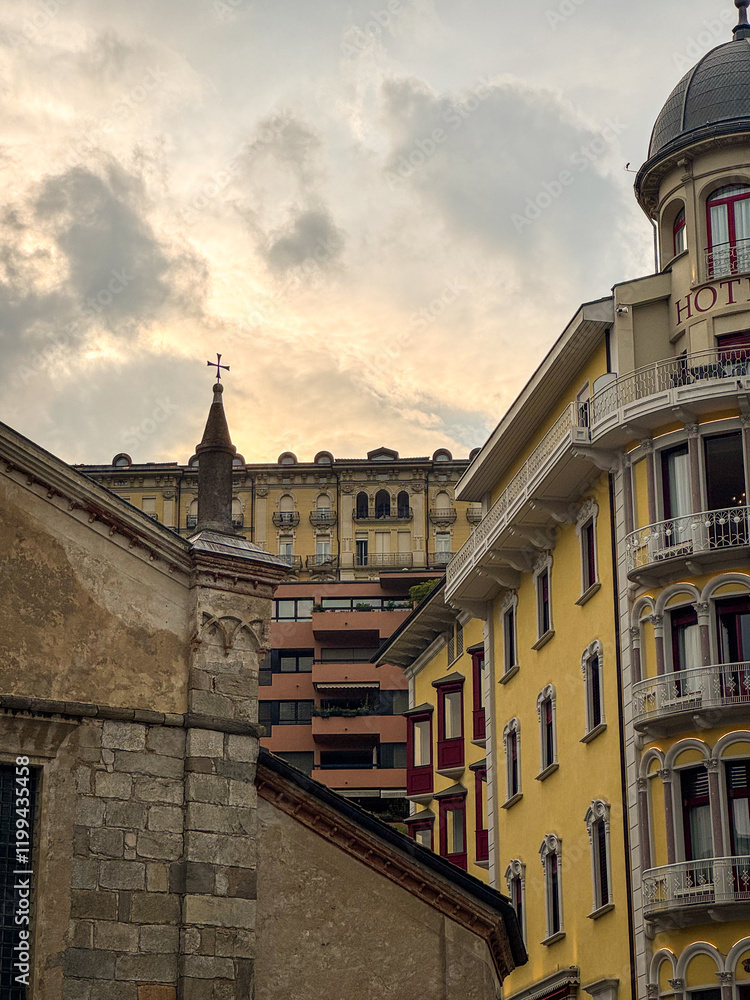 Fototapeta premium Bright Lugano city western European buildings layered behind each other in early sunset, Switzerland