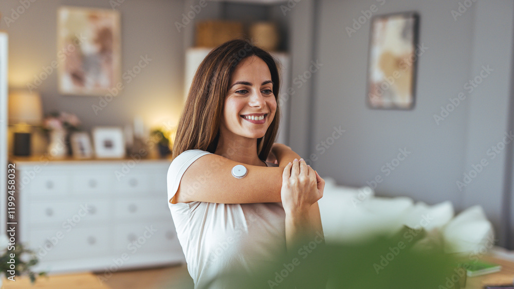 Woman Smiling While Applying Health Monitor at Home in Living Room Woman Smiling While Applying Health Monitor at Home in Living Room