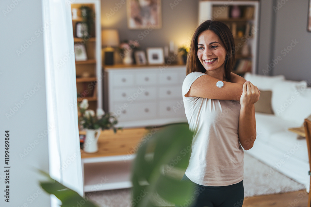Smiling Woman in Cozy Home Checking Health with Sensor Device Smiling Woman in Cozy Home Checking Health with Sensor Device