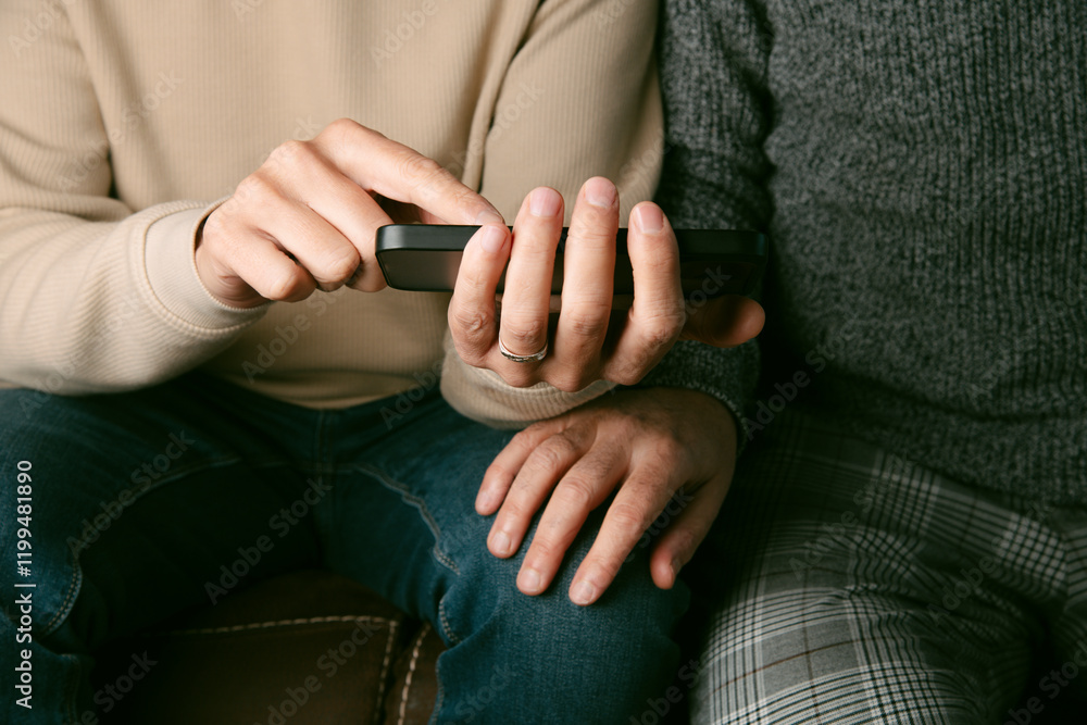 man shows something in his smartphone to his partner man shows something in his smartphone to his partner