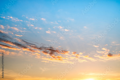 Sky,sunset, beautiful , luxury soft gradient orange gold clouds and sunlight on the blue sky perfect for the background, Sunrise on morning or everning in winter warm time ,Twilight summer,silhouette photo