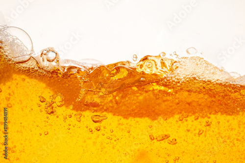 Close up bright orange Oil or beer splash texture and nature waves, Beautiful waves curve and little bubbles smooth for graphic design and background, Oil Bubbles, Soft beer bubbles, Selective focus photo