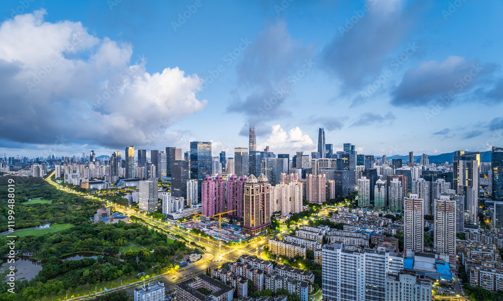 Fototapeta premium Aerial view of Shenzhen city skyline with skyscrapers, roads, and green spaces at dusk