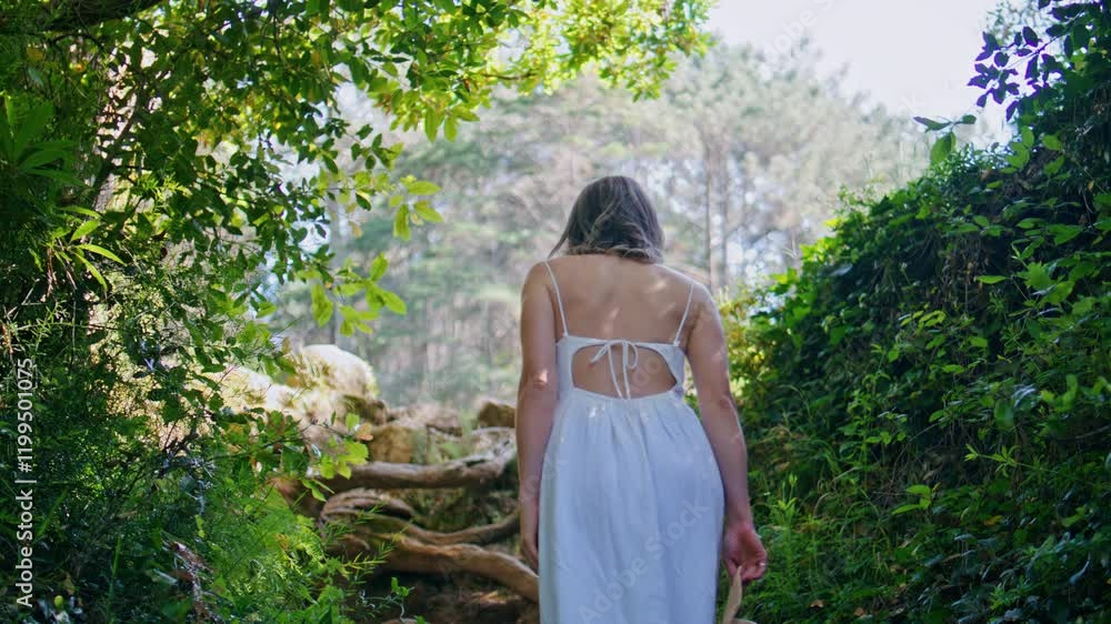 Gorgeous girl going jungles alley with lush greenery back view. Woman walking Gorgeous girl going jungles alley with lush greenery back view. Woman walking
