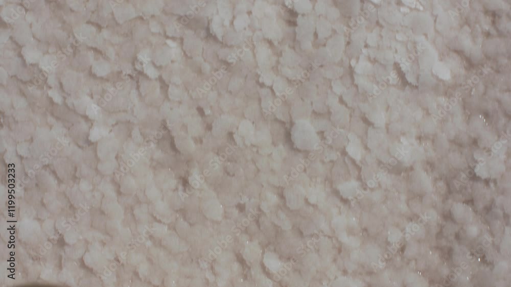 Close-up of a barefoot person stepping on salt crystals in a pink salt lake on a sunny day. The natural texture of the salt and serene atmosphere make this ideal for travel and wellness content. Close-up of a barefoot person stepping on salt crystals in a pink salt lake on a sunny day. The natural texture of the salt and serene atmosphere make this ideal for travel and wellness content.