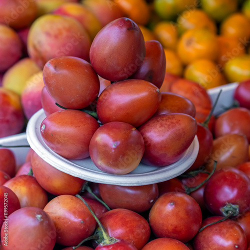 Organic tamarillo (Solanum betaceum) super food fruit on local fruit and vegetable market, Quito, Ecuador. photo