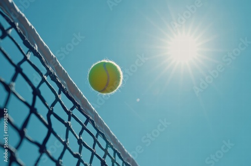 A tennis ball is in the air above a net photo