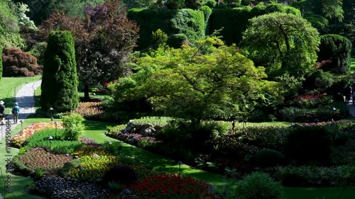 Victoria British Columbia, Canada Butchart Gardens National Historic Site of Canada, the Butchart Gardens, with tourists looking at the sights walking around paths in the Sunken Gardens. photo