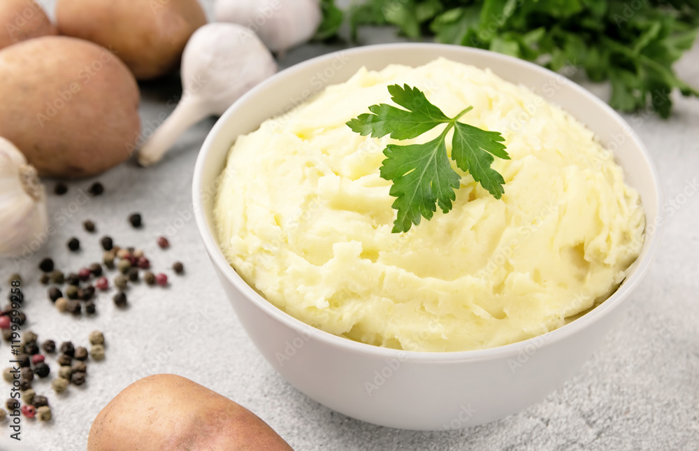 Mashed potatoes in white bowl on grey concrete background. Healthy food Mashed potatoes in white bowl on grey concrete background. Healthy food