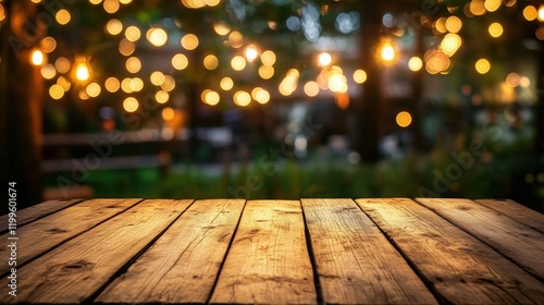 An empty wooden table set for an evening party in a backyard. 
