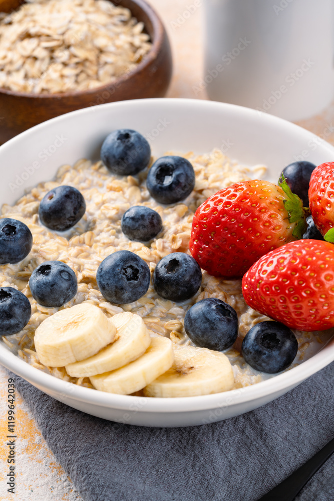 Milk porridge prepared for breakfast with blueberries, strawberries and bananas Milk porridge prepared for breakfast with blueberries, strawberries and bananas