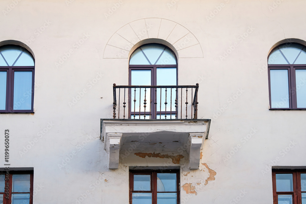 Balcony with cracked plaste, damaged paint, need for facade renovation. Broken plaster on balcony, risk of falling plaster, stucco or concrete pieces on pedestrians