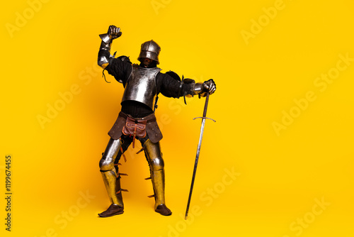 Photos Young man dressed in medieval knight's armor striking a heroic pose against a vi