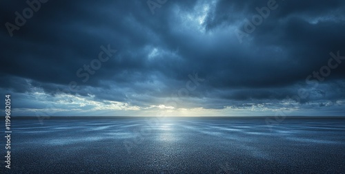 Dramatic stormy sky over dark asphalt road.