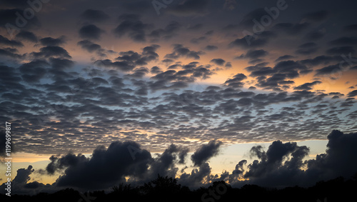 A cloudy twilight landscape with funny intricate silhouettes of evening clouds. Selective focus. photo