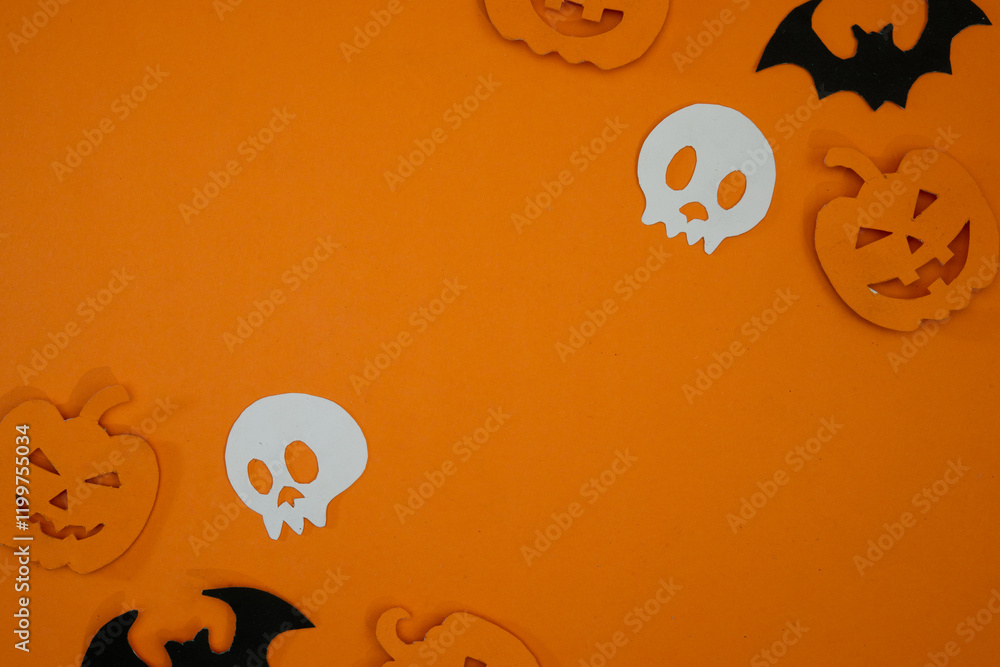 Fototapeta premium Pumpkin and skull paper cut out for copy space background