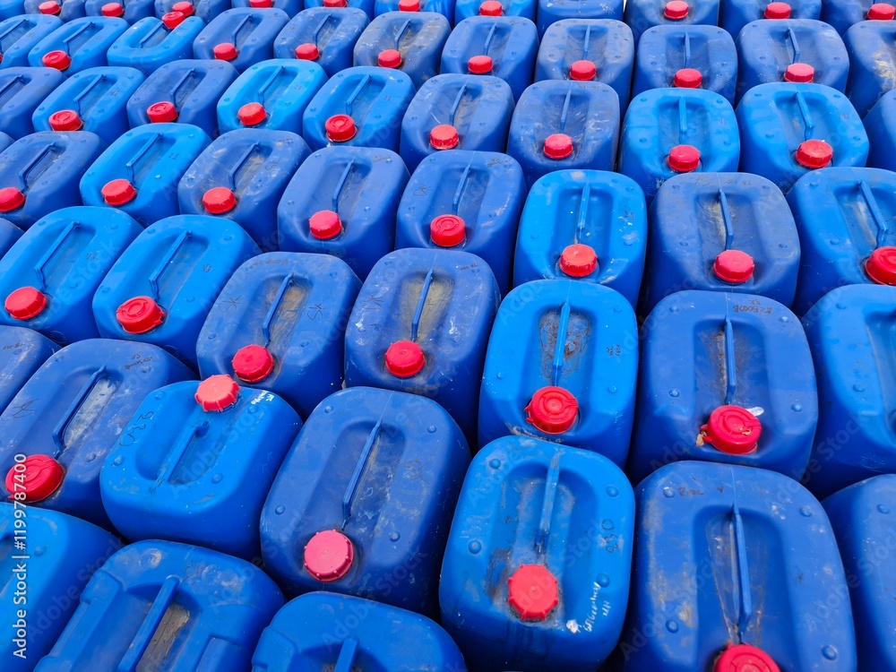 Fototapeta premium Background image of blue oil drums used to refuel fishermen's boats at sea.