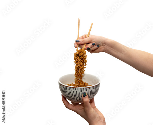 Close-up of a woman's hands holding a porcelain bowl with one hand and with the other one holding delicious Chinese noodles, ramen, with chopsticks on a white background.