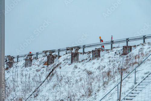 construction of noise barriers on the highway. winter on the expressway. photo