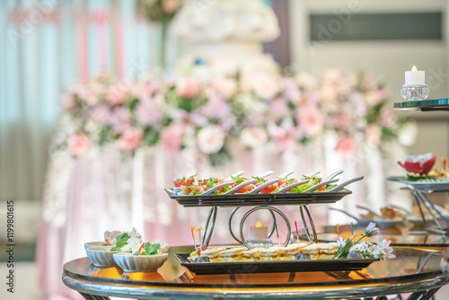 A table full of food with a pink and white decorated background photo