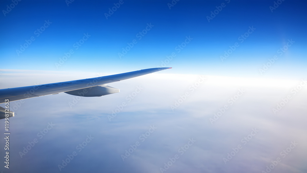 View of airplane wings and sky from airplane window View of airplane wings and sky from airplane window