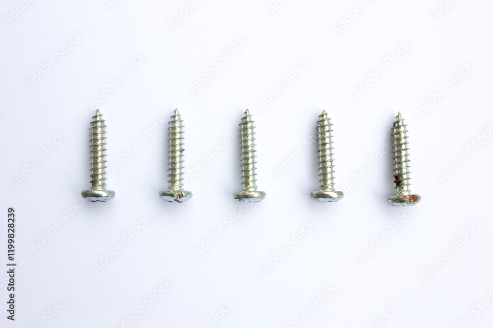 Some silver chromatic screws on white background. Some silver chromatic screws on white background.