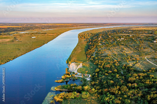 Serenity of a winding Southern Bug River at dusk surrounded by nature's vibrant palette. Aerial photo.
