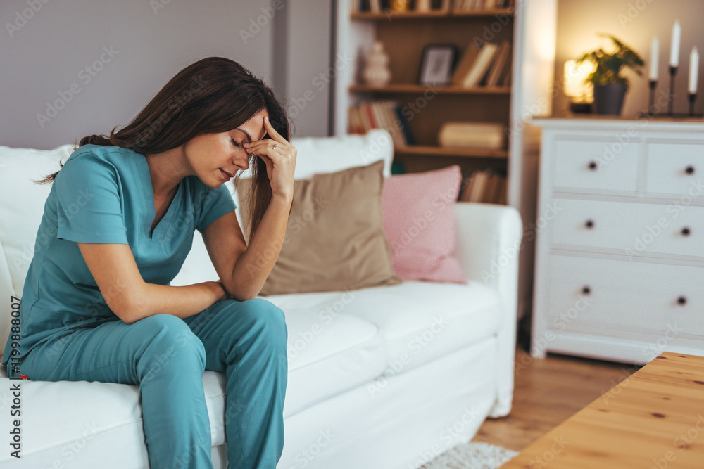 Obraz premium Tired Medical Professional Sitting on Sofa Feeling Stressed in Living Room