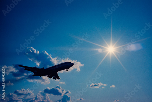 Fotografie Airplane heading for sun