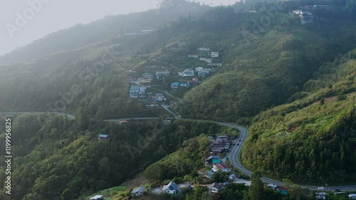 Wallpaper Mural Aerial drone foorage of Winding road cuts through a hillside village, showcasing terraced farms and residential areas.
d farms and residential areas.
 Torontodigital.ca