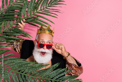 Photo of funny aged man take off sunglass amazed hide palm look empty space wear glamour leopard print clothes isolated on pink background photo