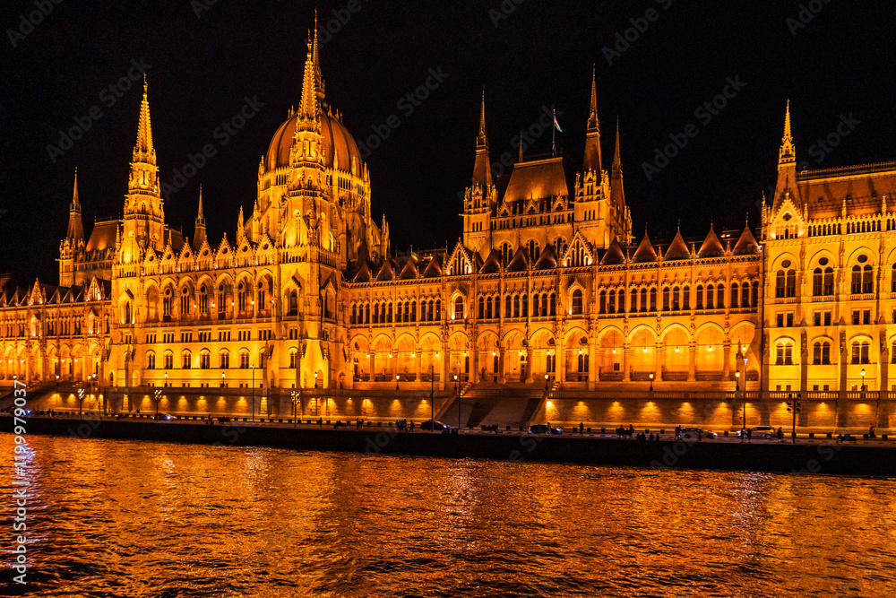 Fototapeta premium Budapest at night. Budapest's Parliament reflecting on the Danube. Nighttime view from the river side. Hungary, Europe.