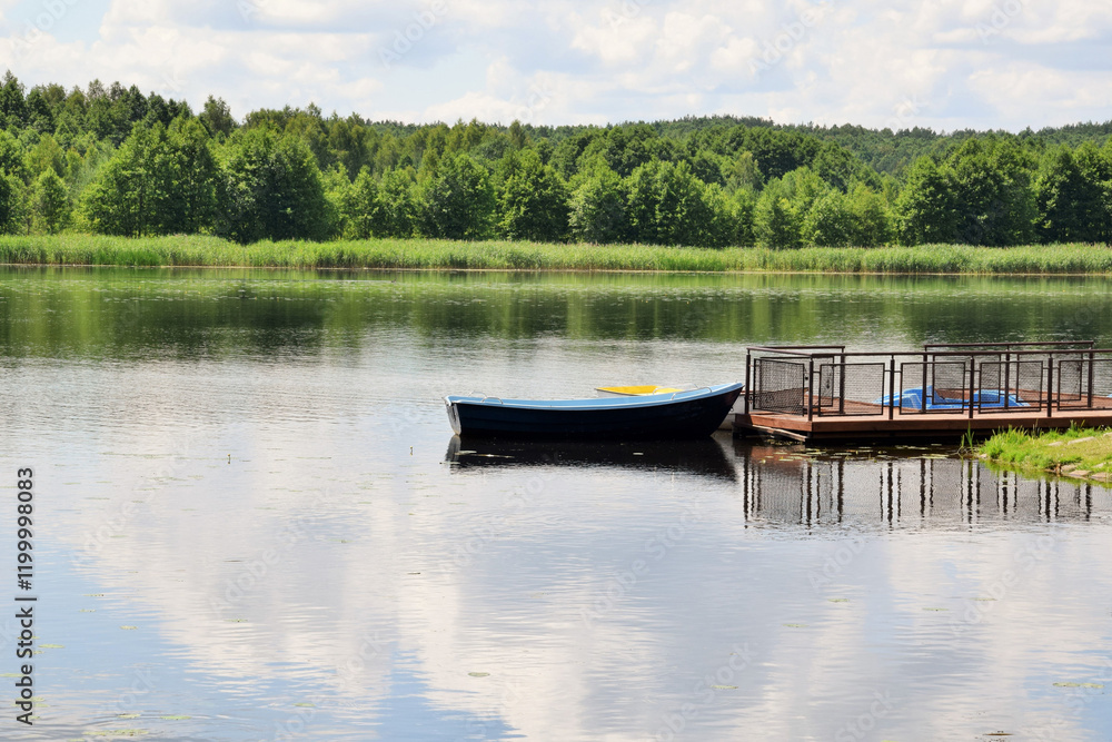 Naklejka premium The pier. The boat is moored with a rope to the pier