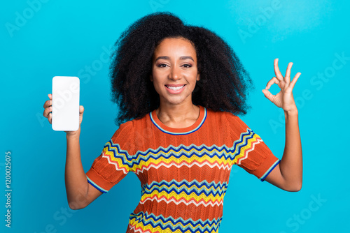 Photo of young girl promoting new updated software for mobile phone demonstrate crypto wallet isolated on blue color background photo