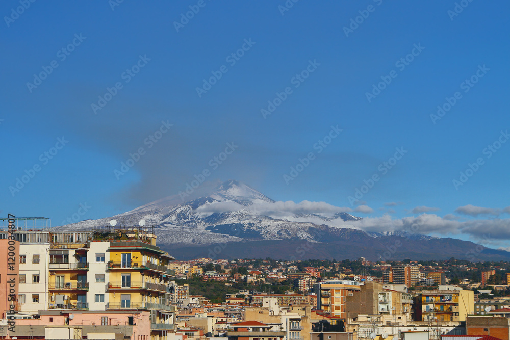 Mount Etna volcano and city, december. Catania, Sicily, Italy