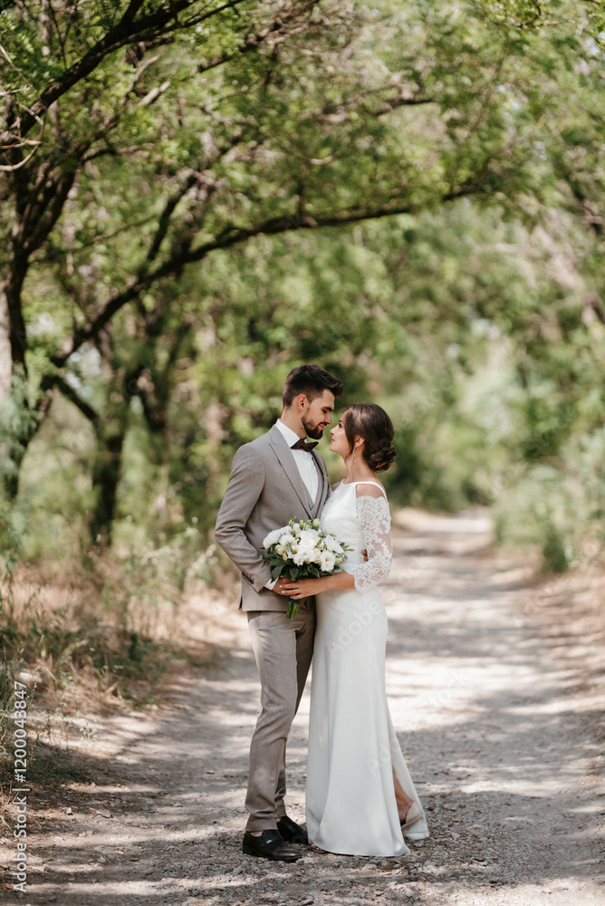 Fototapeta premium guy and a girl newlyweds are walking in the forest