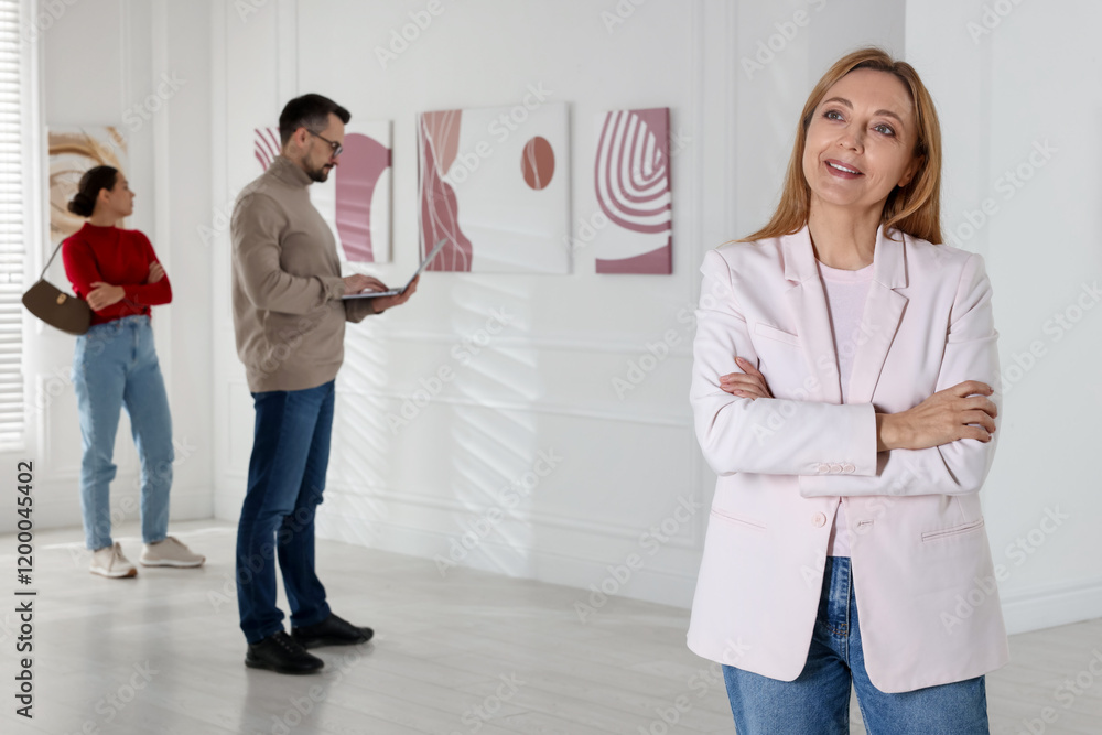 Fototapeta premium Beautiful woman enjoying art in modern gallery