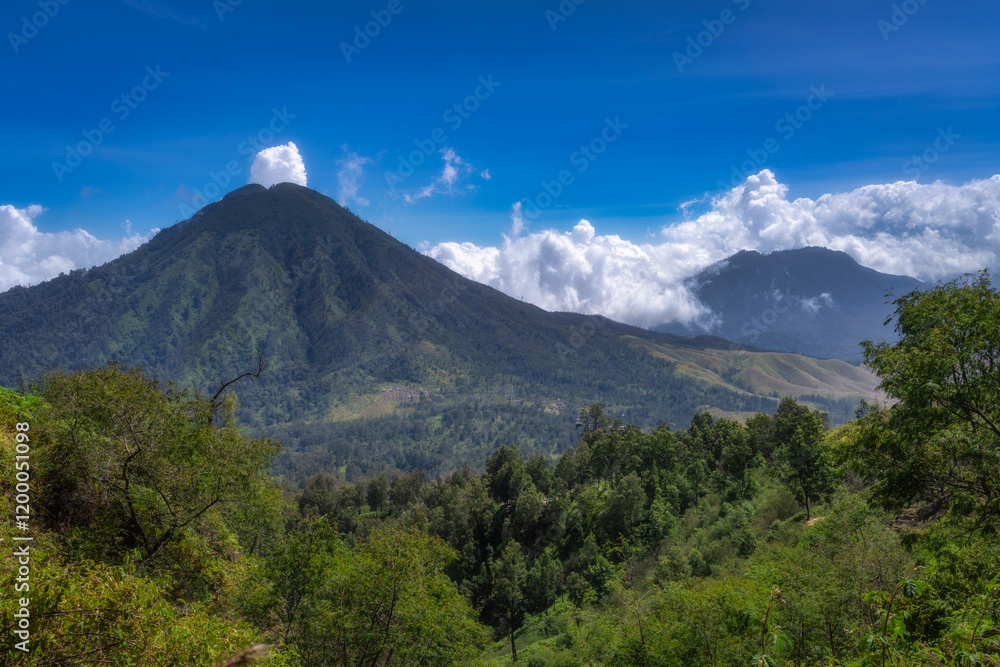 Majestic mountains tower impressively against a clear blue sky, surrounded by vibrant green foliage and fluffy white clouds, showcasing the breathtaking beauty of nature, Java, Ijen Volcano, Indonesia Majestic mountains tower impressively against a clear blue sky, surrounded by vibrant green foliage and fluffy white clouds, showcasing the breathtaking beauty of nature, Java, Ijen Volcano, Indonesia