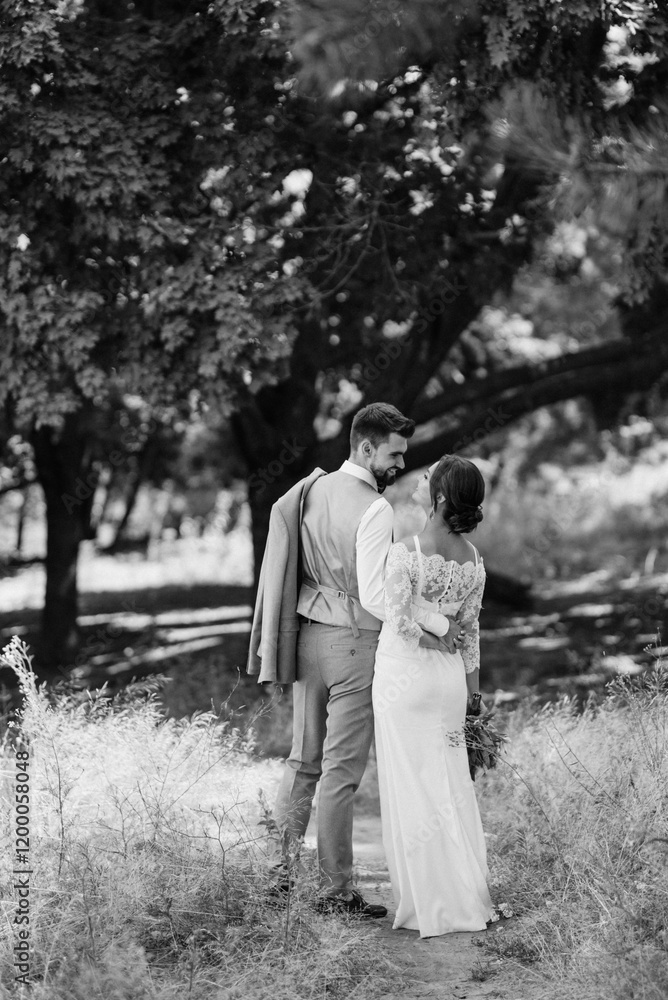 guy and a girl newlyweds are walking in the forest