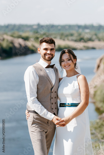 bride blonde girl and groom near the river