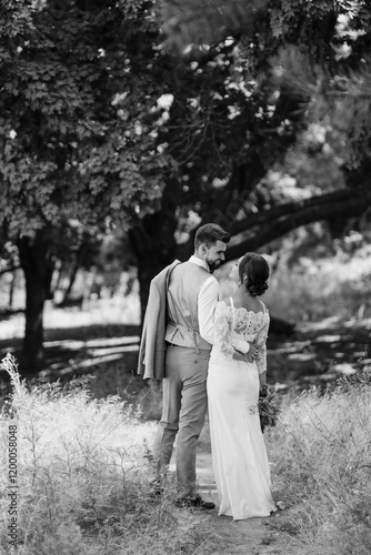 Obraz na płótnie guy and a girl newlyweds are walking in the forest w salonie