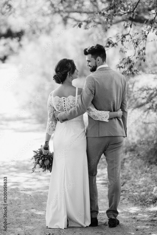 guy and a girl newlyweds are walking in the forest