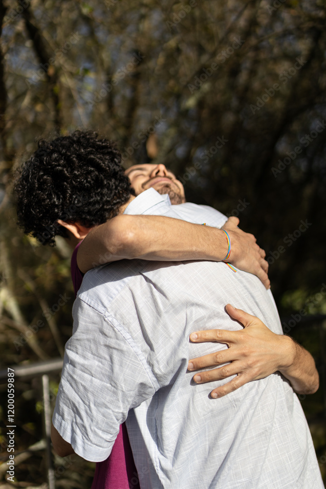 Brazilian gay couple hugging in a park Brazilian gay couple hugging in a park