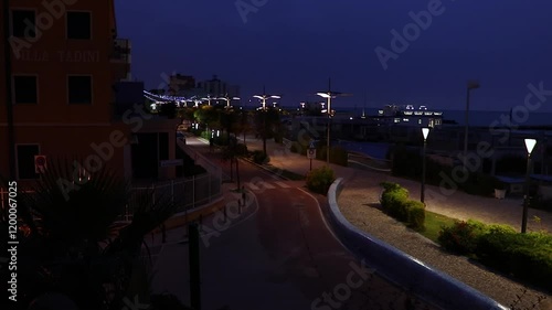 Wallpaper Mural Night scene of Rimini boardwalk right by the beach with street lights and many hotels in the surrounding area, summer in Italy. Torontodigital.ca