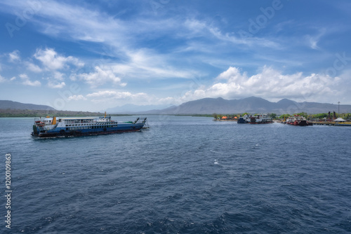 Obraz na płótnie A serene and tranquil harbor is beautifully showcasing various boats floating gracefully on calm waters, all surrounded by majestic mountains under a bright blue sky, Bali, East Java, Indonesia w salonie