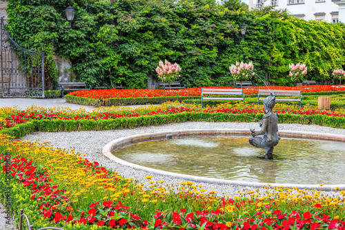 sunny day Salzburg city famous tourist garden with flowers castle Mirabella Austria
