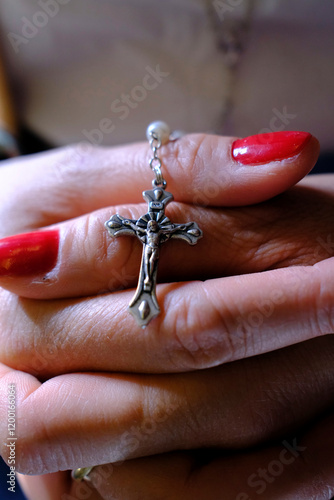 Catholic woman praying the rosary on a plane. photo