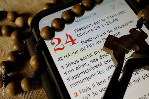 Rosary and digital bible on a smartphone. New testament. The Olivet Discourse.