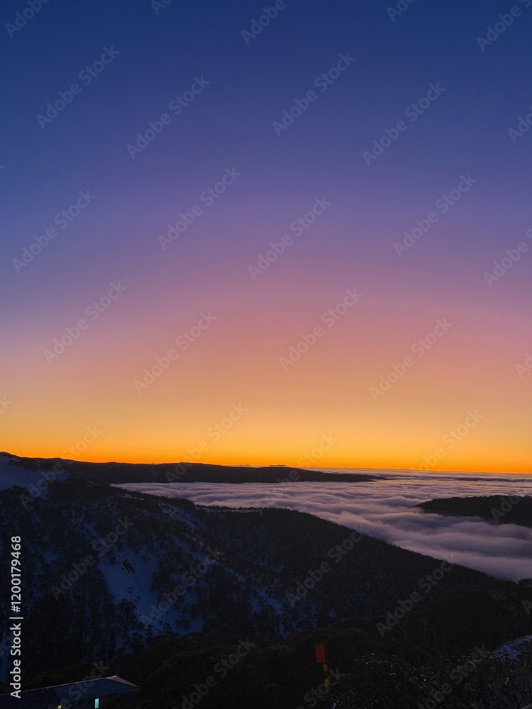 Sunset Over Mountain Range with Rolling Clouds Sunset Over Mountain Range with Rolling Clouds